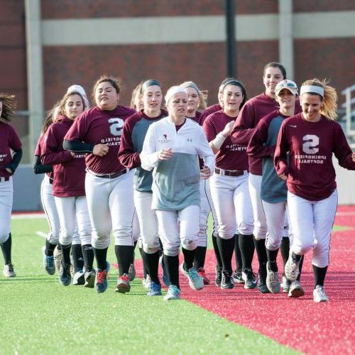 Women's softball team running. 